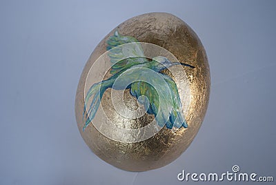 Easter egg hand made. Golden egg with the bird painted Stock Photo