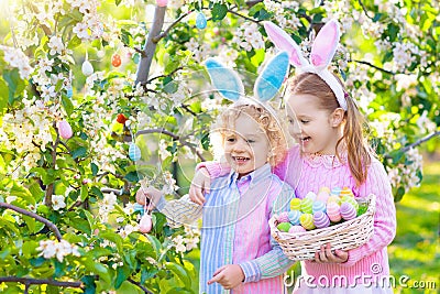 Easter egg hunt. Kids with bunny ears and basket. Editorial Stock Photo