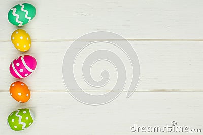 Easter egg side border against white wood Stock Photo