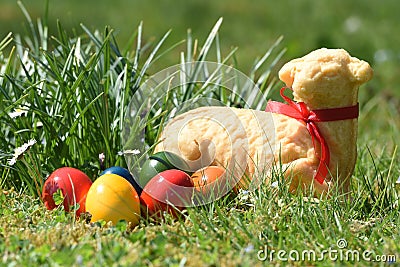 Easter eggs and a baked Easter lamb in a meadow Stock Photo