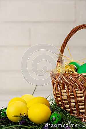 Easter eggs in the basket and with fake grass Stock Photo