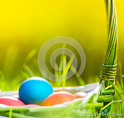 Easter eggs in basket on grass Stock Photo