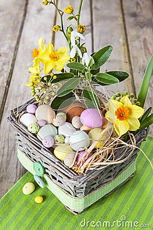 Easter eggs in the basket on green striped cloth Stock Photo