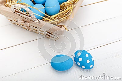 Easter eggs in a basket on rustic wooden background, selective focus image, Happy Easter Stock Photo