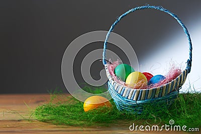 Easter eggs in a basket on a wooden table. Stock Photo