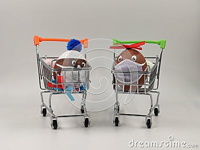 Easter eggs a boy and a girl wearing medical masks met on grocery carts. Stock Photo