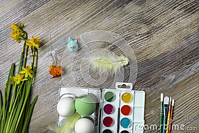 Easter eggs and colorful paints and brushes, decorative chickens Stock Photo