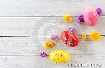 Easter eggs decoration with colorful flowers white wooden background Stock Photo