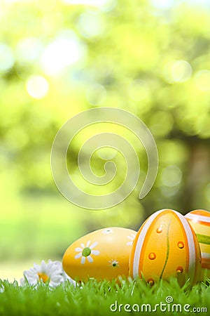 Easter eggs on a green meadow, bokeh in the background Stock Photo