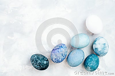 Easter eggs with marble stone effect painted with natural dye carcade flower on grey concrete background Stock Photo
