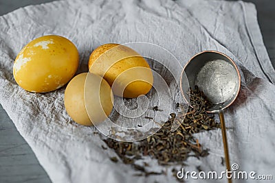 Easter eggs naturally dyed with green tea. Selective focus on vintage scoop Stock Photo