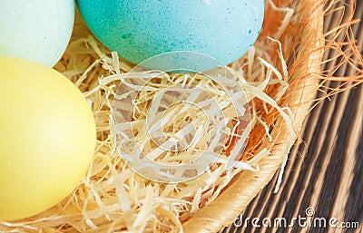 Easter eggs in nest on wooden background Stock Photo