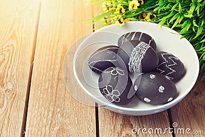 Easter eggs painted with chalkboard paint on wooden background Stock Photo