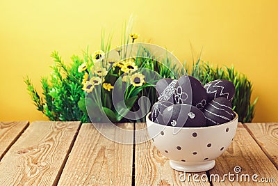 Easter eggs painted with chalkboard paint on wooden table Stock Photo