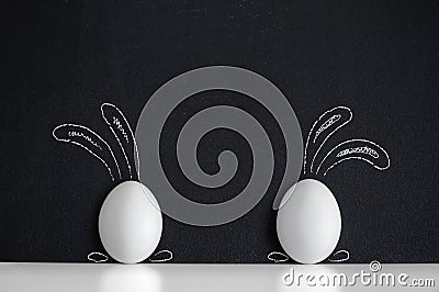 Easter eggs painted like rabbits on the black background Stock Photo