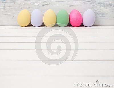 Easter eggs painted in pastel colors on white wood Stock Photo