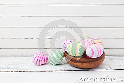 Easter eggs painted in pastel colors on white wood Stock Photo