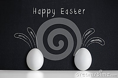 Easter eggs with painted rabbits on the black background Stock Photo