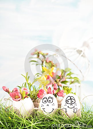Easter eggs pink yellow flowers green grass Stock Photo