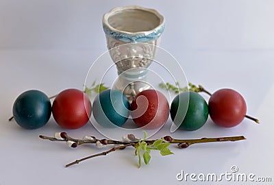 Easter eggs stacked in a row and an icon lamp Stock Photo