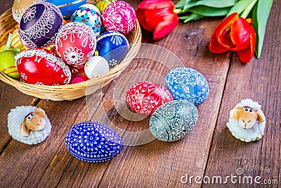 Easter eggs with tulips on weathered wooden background Stock Photo