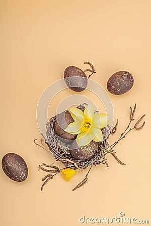 Easter eggs, wooden bunnies and bird's nest with chicken and narcissus flower. Festive concept Stock Photo