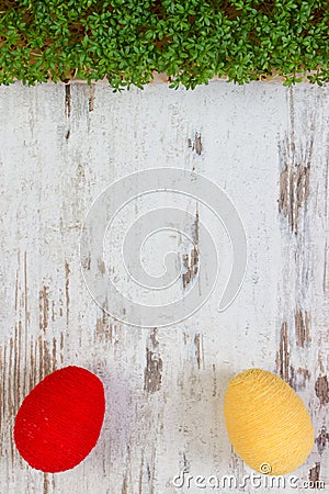 Easter eggs wrapped woolen string and green cress on wooden background, copy space for text, decoration for Easter Stock Photo