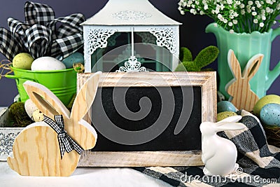 Easter farmhouse vignette with bunnies, Easter eggs and buffalo plaid check. Stock Photo