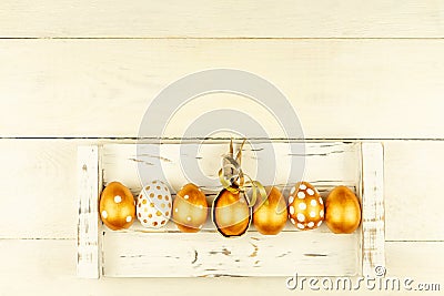 Easter festive decoration. Top view of easter eggs colored with golden paint and empty mock-up photo frame. Various dotted designs Stock Photo