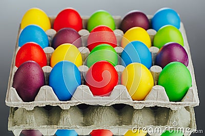 Easter festive multicolor eggs carton, gray background Stock Photo