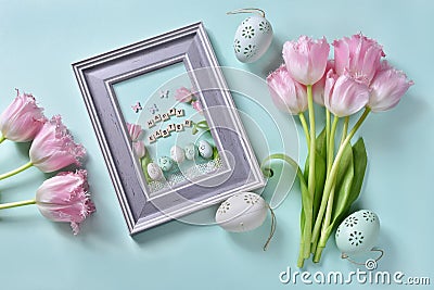 Easter flat lay with bunch of pink tulips and greeting card in a frame Stock Photo