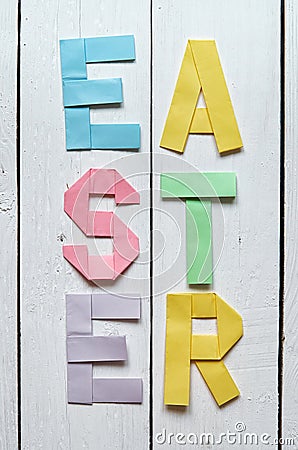 Easter folded paper origami colorful lettering on white wooden planks rustic background Stock Photo