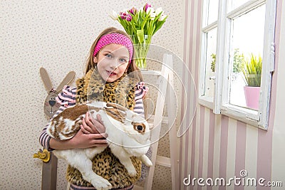 Easter - Girl carries a huge rabbit live Stock Photo