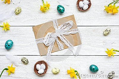 Easter greeting card with envelope in frame made of quail eggs, spring flowers and feathers Stock Photo