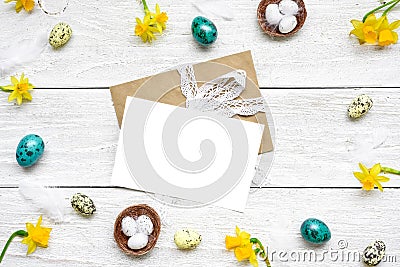 Easter greeting card in frame made of quail eggs, spring flowers and feathers. easter composition Stock Photo