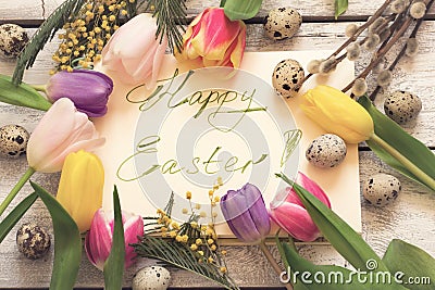 Easter greeting card with handwritten font, spring flowers and e Stock Photo