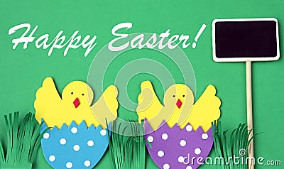 Easter hand made greeting card: hatched chicken in eggshell with blackboard isolated on green background Stock Photo