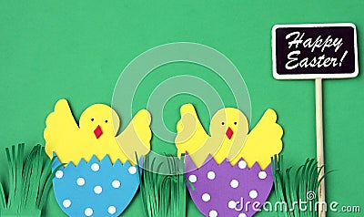 Easter hand made greeting card: hatched chicken in eggshell with blackboard isolated on green background Stock Photo