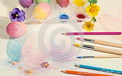 Easter hand-painted eggs with colored pencils,watercolors and spring flowers,arranged on colored drawing. Stock Photo