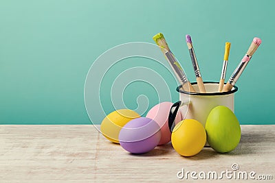 Easter holiday background with handmade painted eggs and brushes Stock Photo