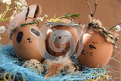 Easter holiday concept with cute handmade eggs, rabbit, chicks, owl, panda and deer. Creative eggs for Easter. Stock Photo