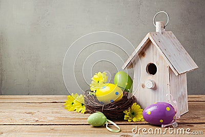 Easter holiday concept with eggs decorations and bird house Stock Photo