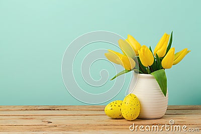 Easter holiday concept with tulip flowers and eggs decorations on wooden table Stock Photo