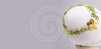 Easter holiday egg on a banner embroidery with ribbons on a real white egg is handmade instead For text advertising Stock Photo