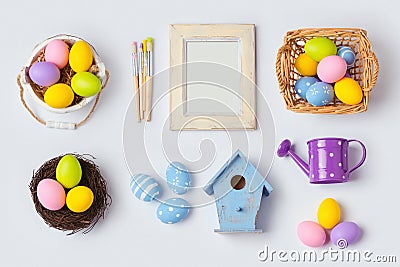 Easter holiday eggs decorations and photo frame for mock up template design. View from above. Stock Photo
