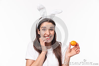 Easter, holidays and spring concept. Close-up portrait of silly and cute, happy giggling girl in rabbit ears, made her Stock Photo