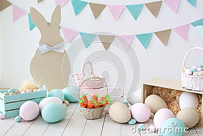 Easter! Many colorful Easter eggs with bunnies and baskets! Easter decoration of the room, children`s room for games. Basket with Stock Photo