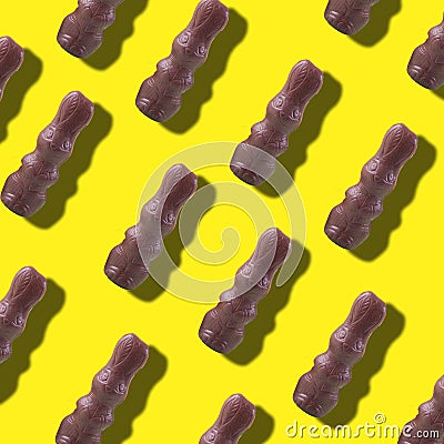 Easter pattern, chocolate bunny on a yellow background. Stock Photo