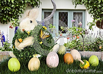 Easter Rabbit & Eggs In Green Grass With Cottage Stock Photo
