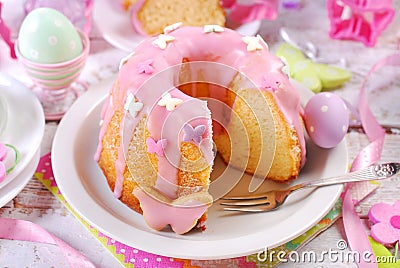 easter ring cake with pink icing and butterfly shaped sugar sprinkles Stock Photo